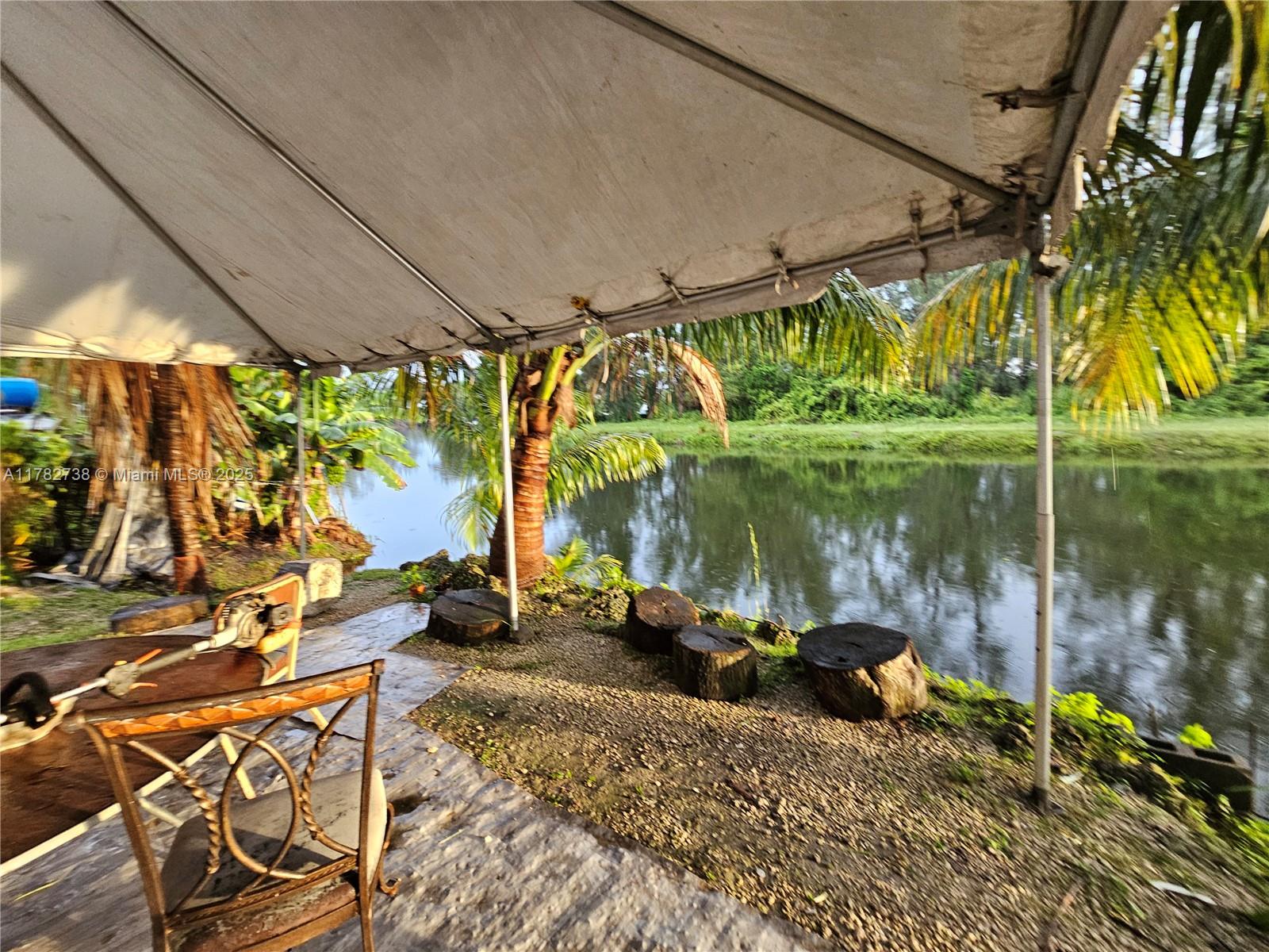 Westview Miami, FL 33167 - Photo 13 of 46 a backyard of a house with a fountain swing table and chairs