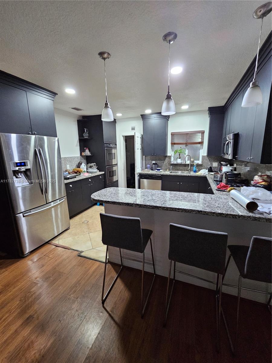 Westview Miami, FL 33167 - Photo 24 of 46 a large kitchen with a table and chairs