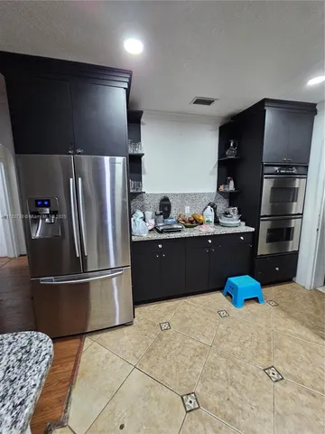 a kitchen with stainless steel appliances a refrigerator and a sink
