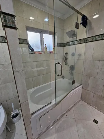 a bathroom with a shower and a toilet