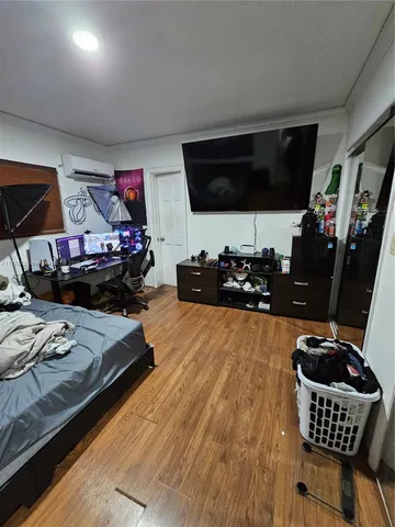 a bed room with furniture and a flat screen tv