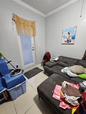 a room with storage and a flat screen tv