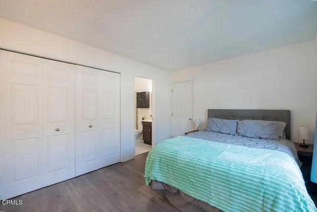 a bedroom with a bed and a closet