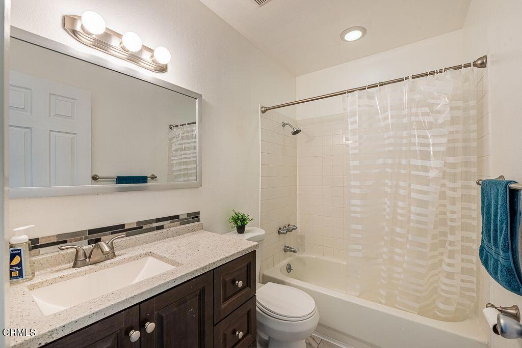2250 North Goddard Avenue Simi Valley, CA 93063 - Photo 19 of 25 a bathroom with a sink vanity mirror and shower