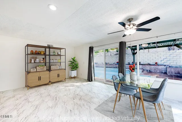 a view of a workspace with furniture and a kitchen