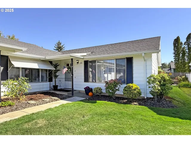 a view of a house with garden and yard