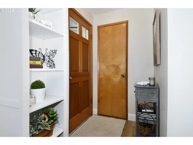 a view of kitchen with refrigerator and cabinets