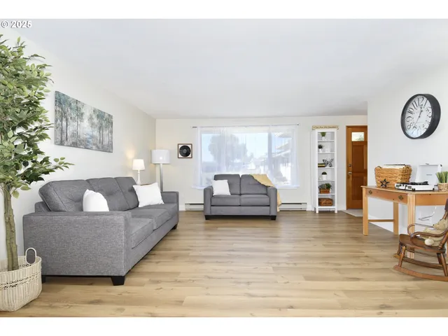 a living room with furniture and a large mirror