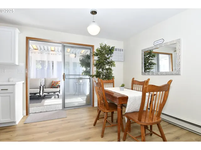 a dining room with furniture and a floor to ceiling window