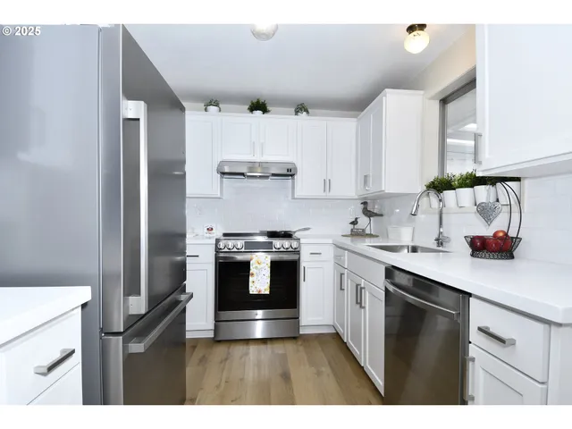 a kitchen with kitchen island a sink stainless steel appliances and cabinets