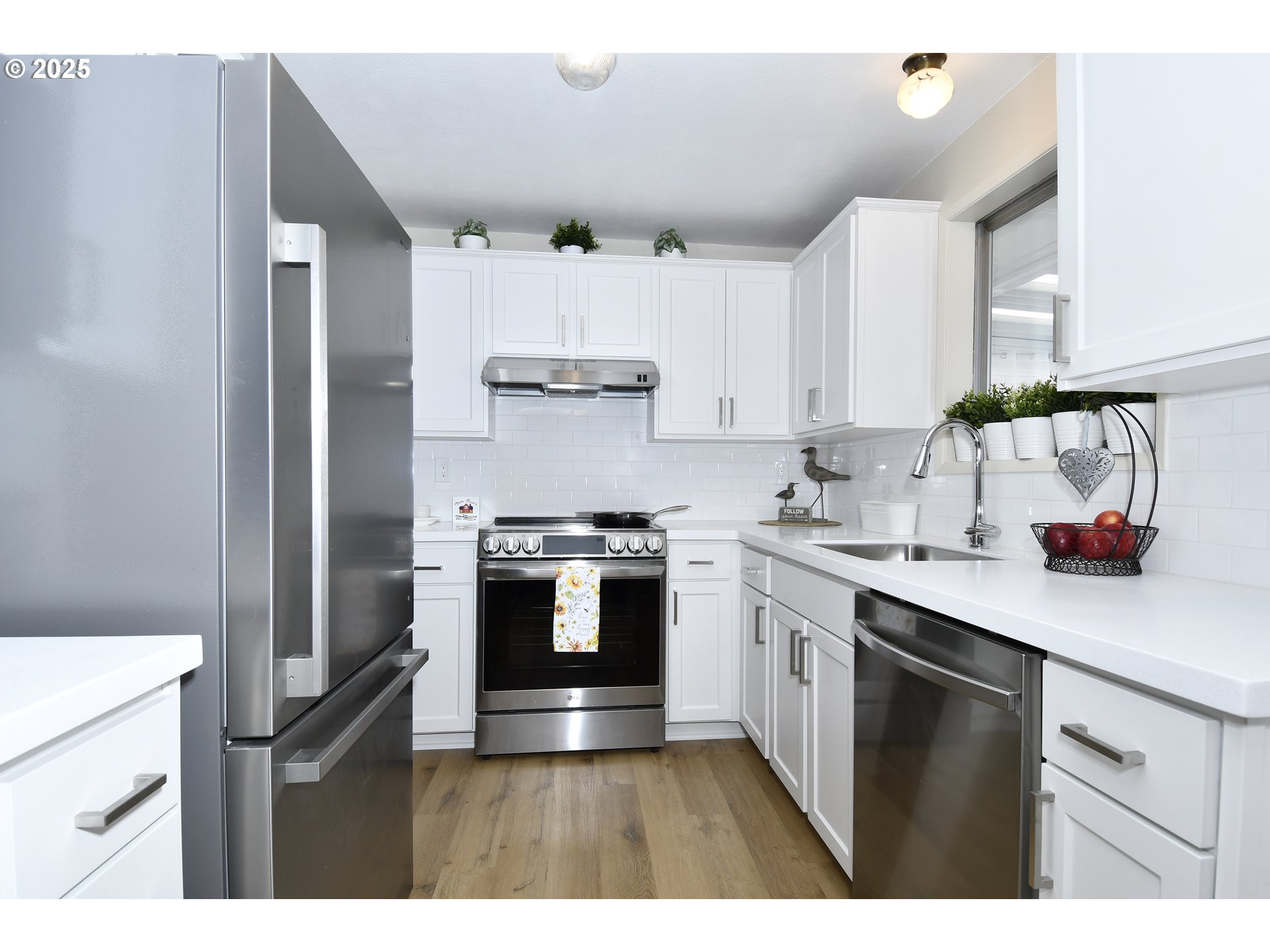 626 Northeast Fleming Avenue, Unit B63 Gresham, OR 97030 - Photo 21 of 45 a kitchen with kitchen island a sink stainless steel appliances and cabinets