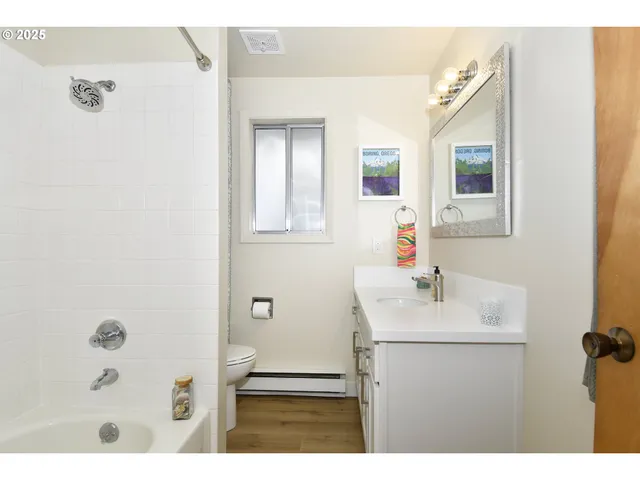 a bathroom with a sink mirror and vanity