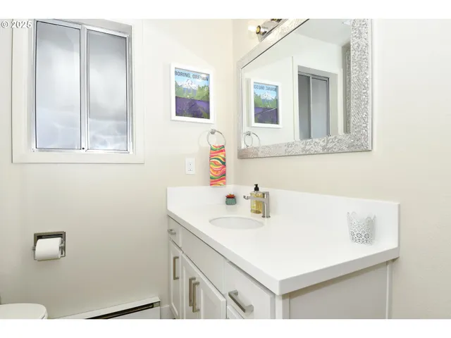a bathroom with a sink vanity and a mirror