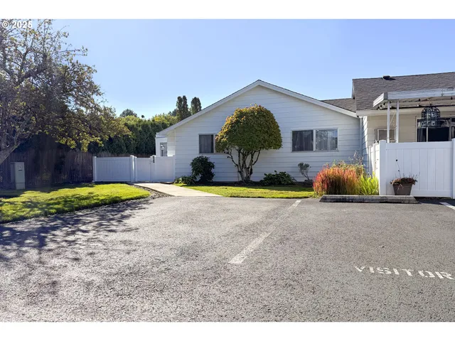 a view of a house with backyard and swimming pool