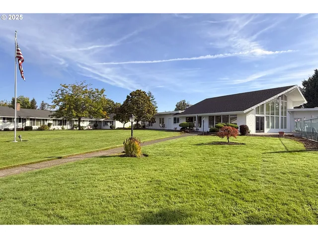a living room with lots of furniture and view of kitchen