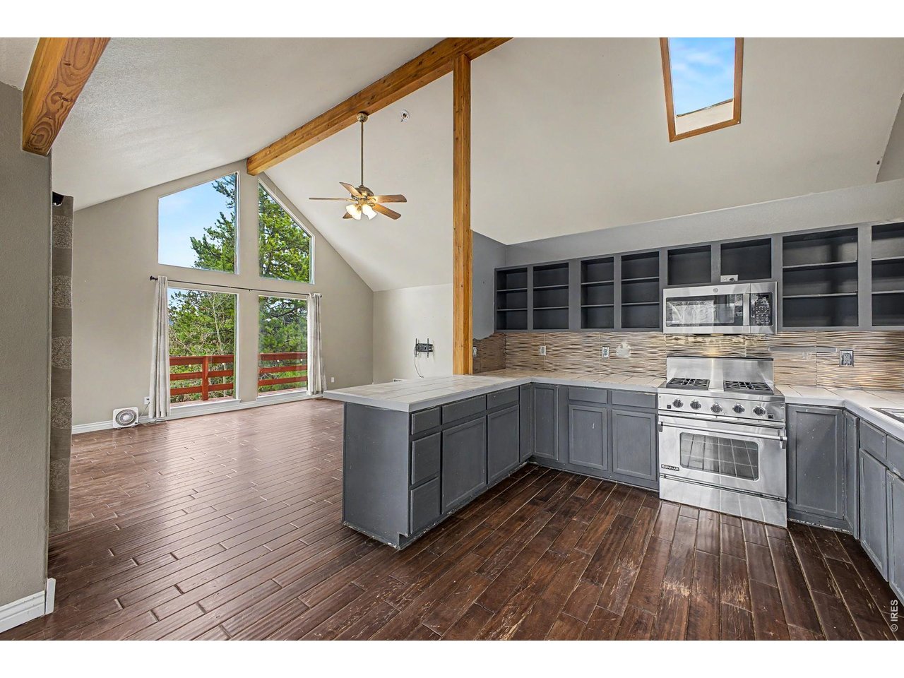 76 Highlands Drive Bailey, CO 80421 - Photo 10 of 49 a kitchen with stainless steel appliances wooden floors and wooden cabinets