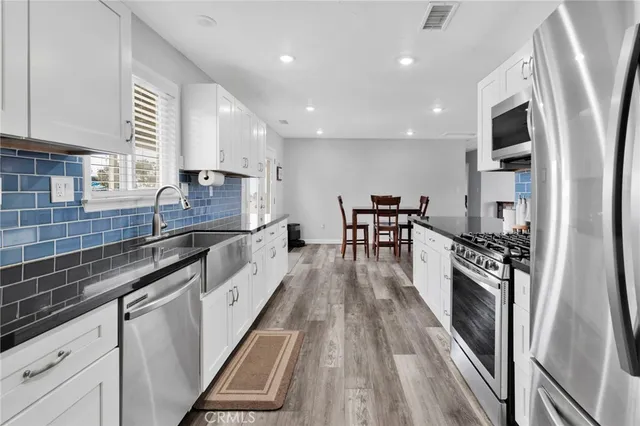 a kitchen with granite countertop lots of counter top space and stainless steel appliances