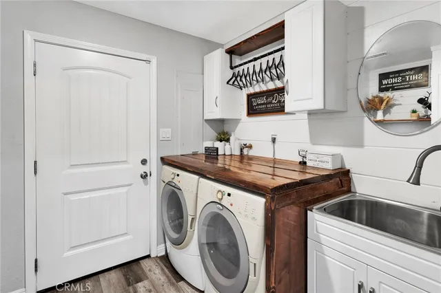 a utility room with sink dryer and washer