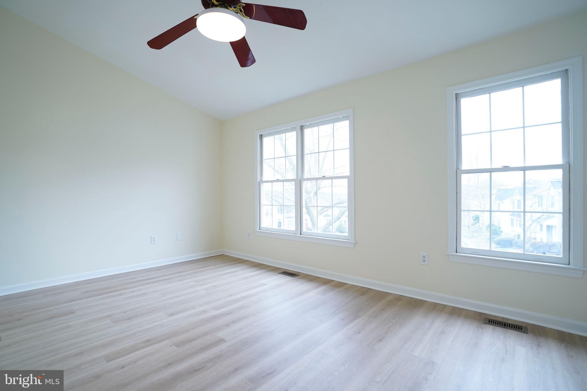 6903 Compton Lane Centreville, VA 20121 - Photo 18 of 35 a view of an empty room with wooden floor and a window