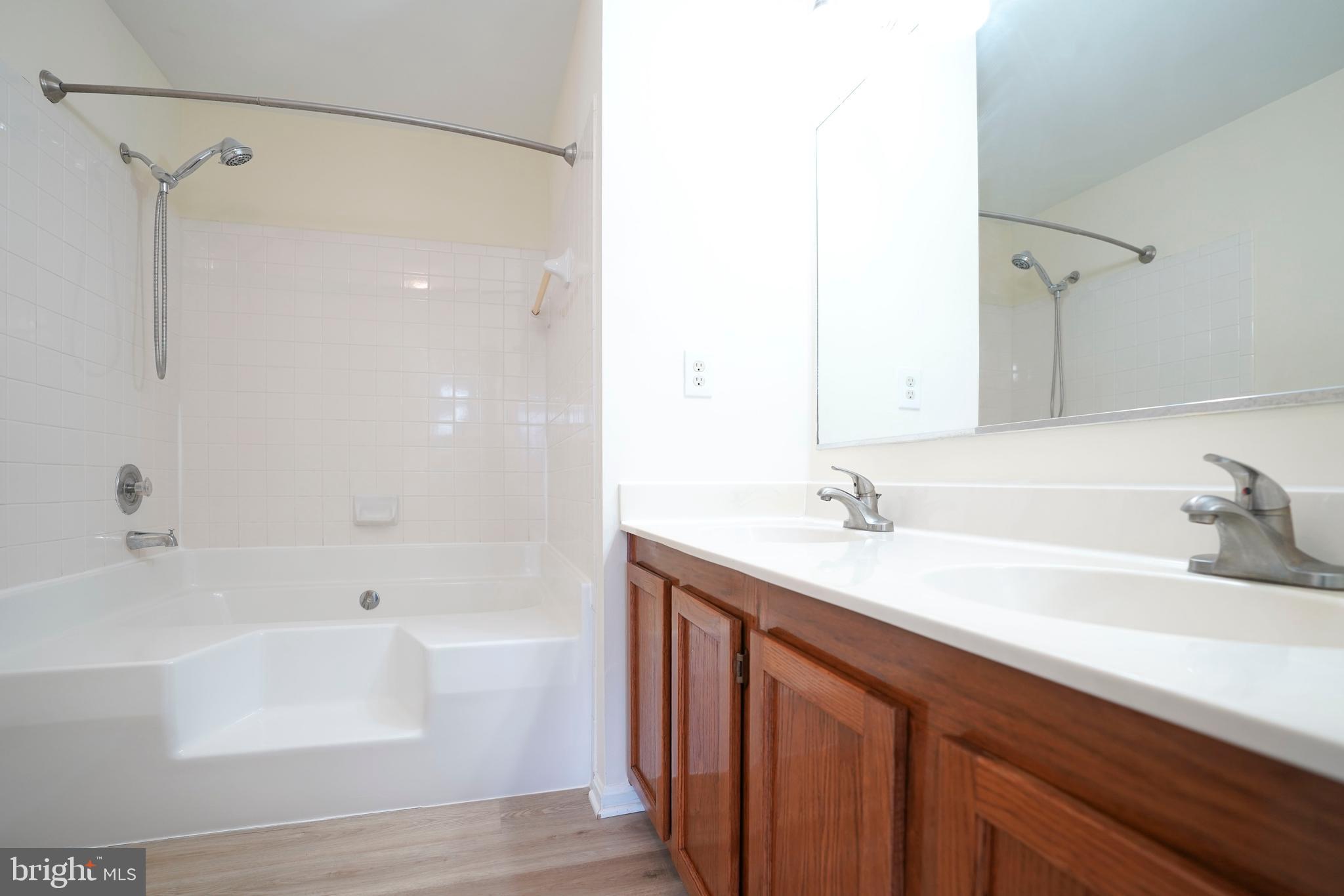 6903 Compton Lane Centreville, VA 20121 - Photo 21 of 35 a bathroom with a tub sink and mirror
