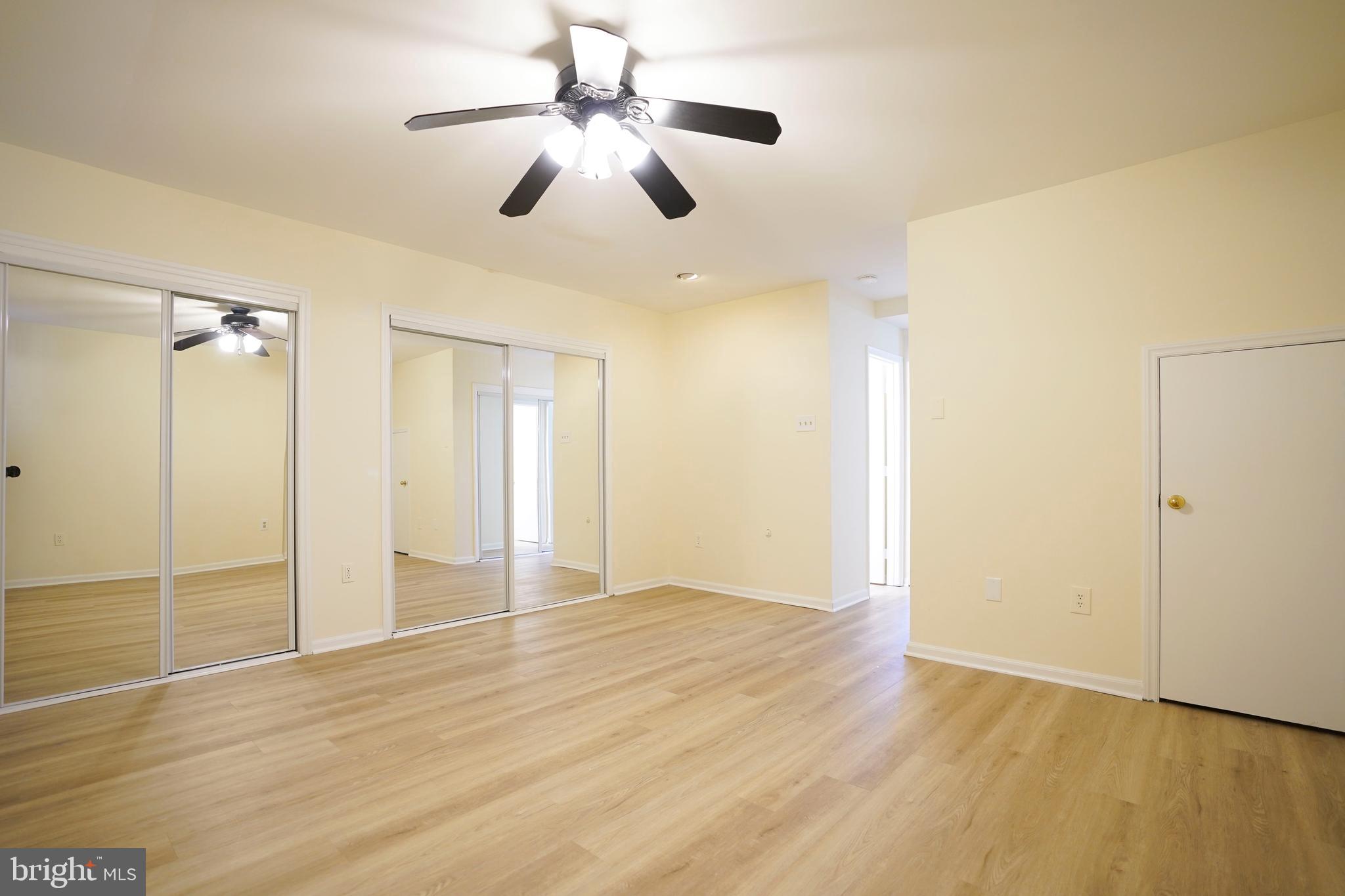 6903 Compton Lane Centreville, VA 20121 - Photo 27 of 35 a view of an empty room with wooden floor and a ceiling fan