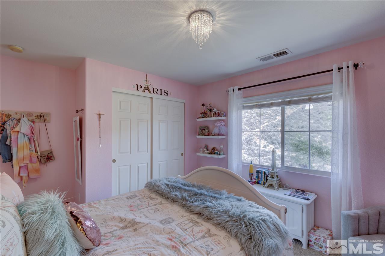7638 Corso Street Reno, NV 89506 - Photo 16 of 29 a bedroom with a bed and a window