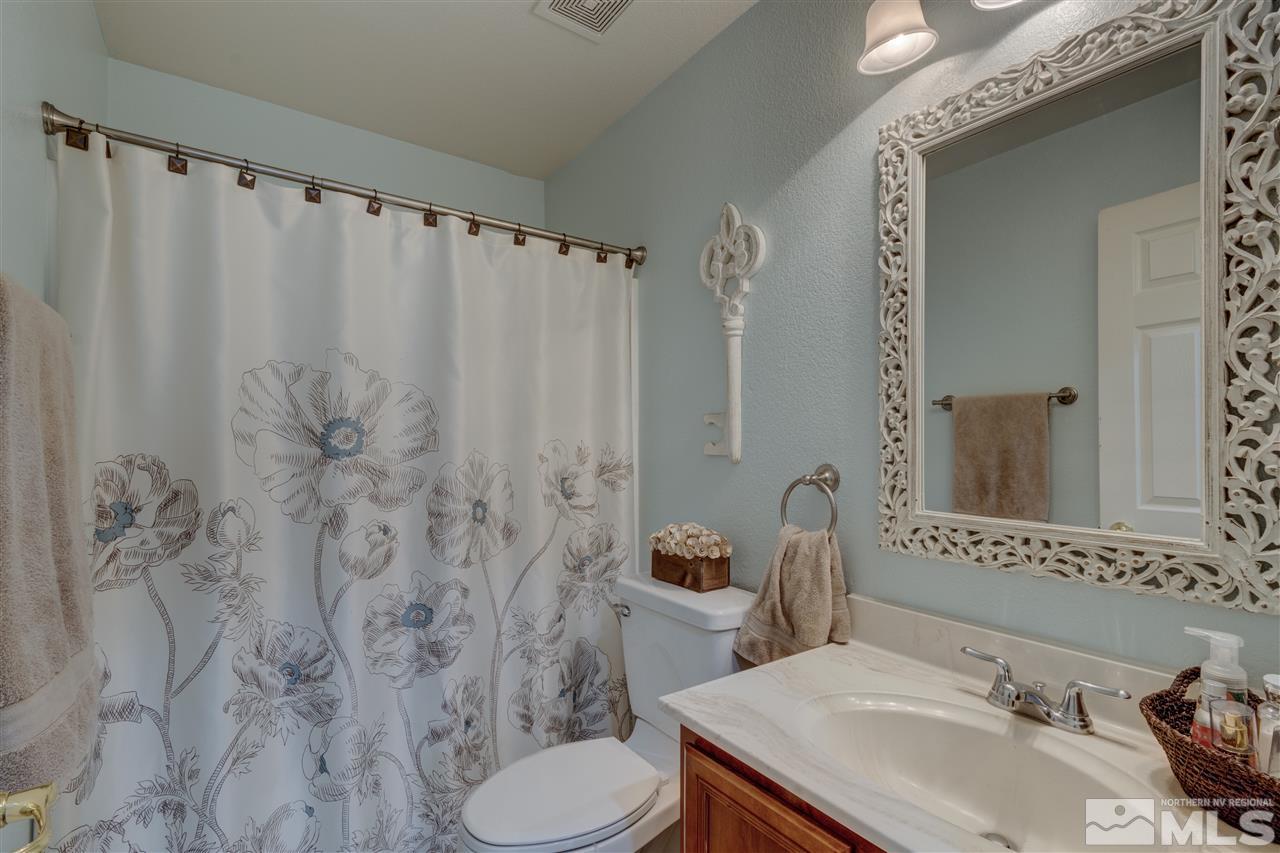 7638 Corso Street Reno, NV 89506 - Photo 19 of 29 a bathroom with a toilet sink and mirror