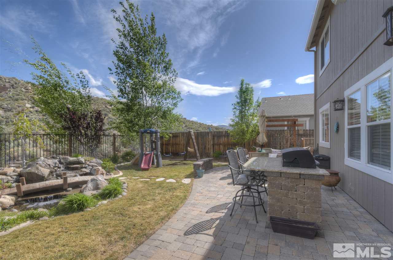 7638 Corso Street Reno, NV 89506 - Photo 21 of 29 a view of a patio with table and chairs potted plants with wooden floor