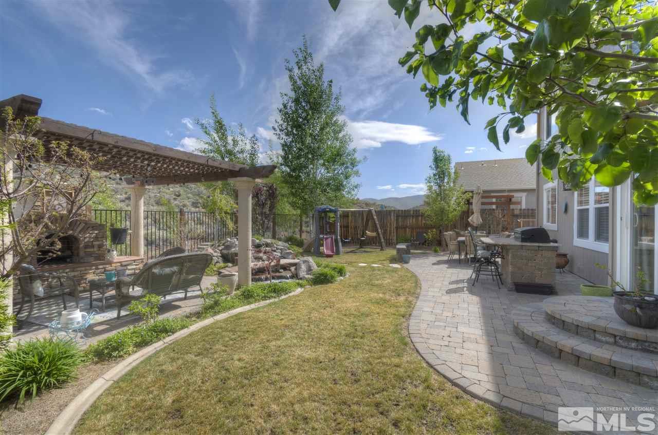 7638 Corso Street Reno, NV 89506 - Photo 25 of 29 outdoor view of a house with backyard porch and sitting area