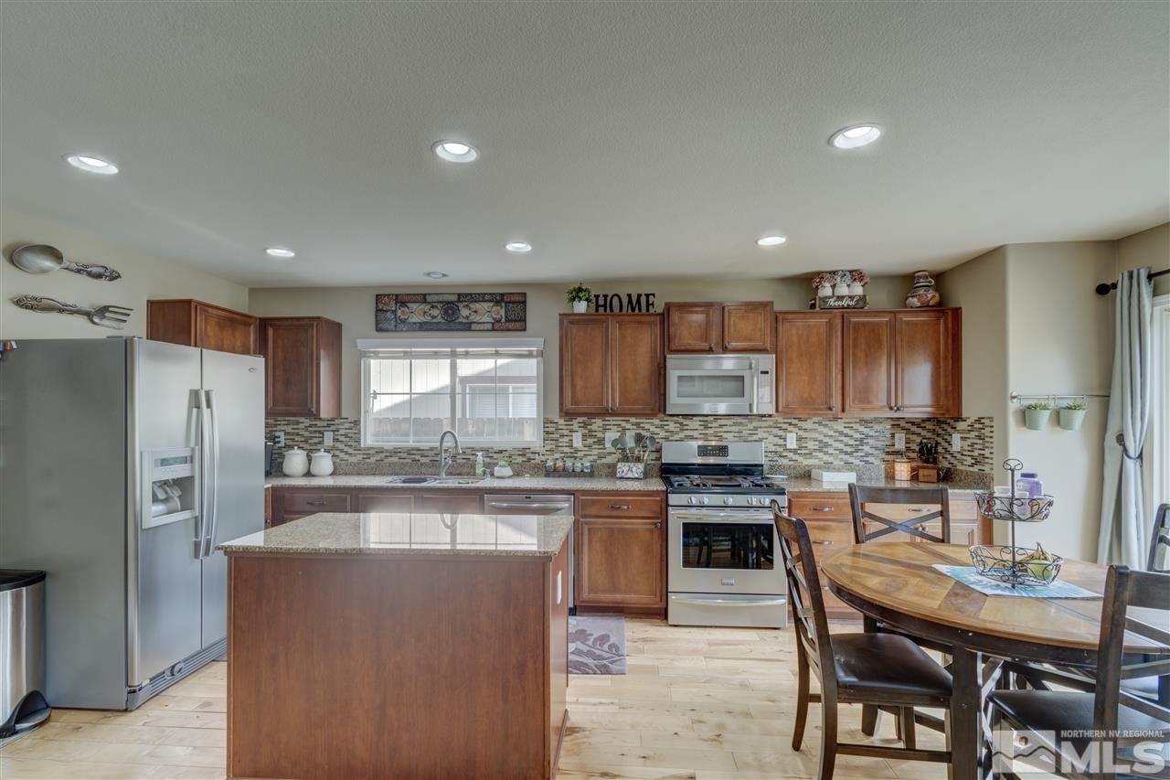 7638 Corso Street Reno, NV 89506 - Photo 5 of 29 a kitchen with refrigerator and cabinets