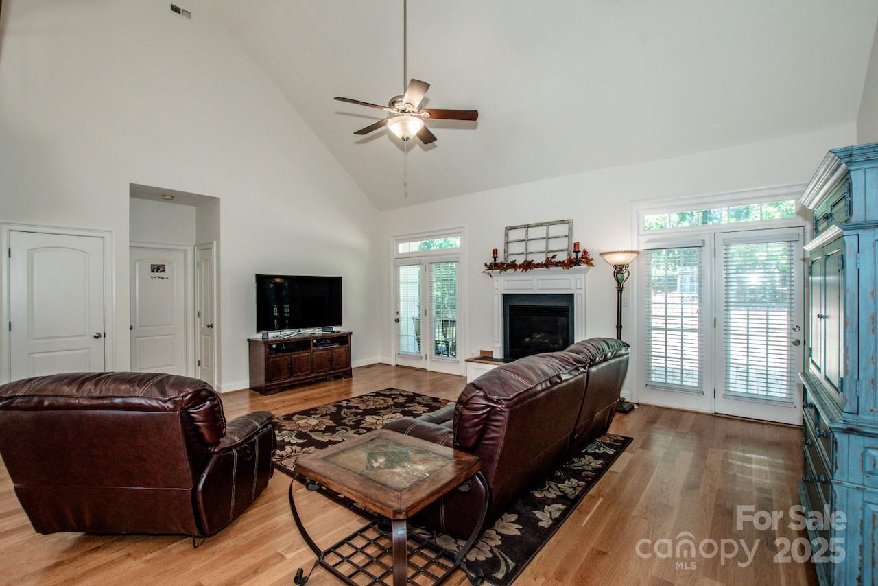 3545 Maple Brook Drive Denver, NC 28037 - Photo 12 of 40 a living room with furniture a flat screen tv and a fireplace