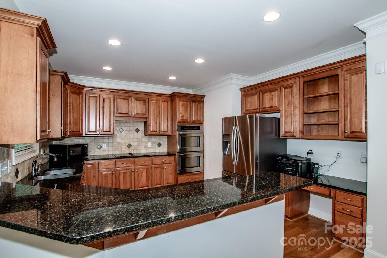 3545 Maple Brook Drive Denver, NC 28037 - Photo 14 of 40 a kitchen with stainless steel appliances granite countertop a refrigerator sink and stove