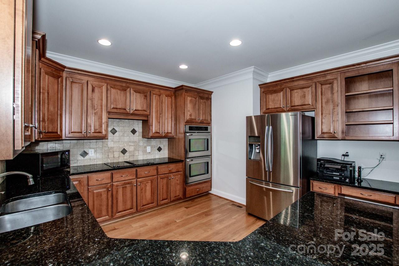 3545 Maple Brook Drive Denver, NC 28037 - Photo 15 of 40 a kitchen with stainless steel appliances granite countertop a refrigerator sink and stove