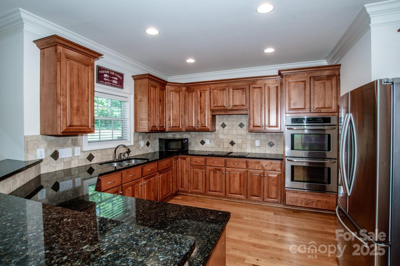 3545 Maple Brook Drive Denver, NC 28037 - Photo 16 of 40 a kitchen with stainless steel appliances granite countertop a refrigerator sink and cabinets