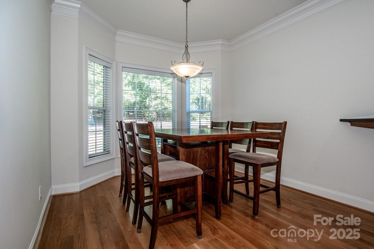 3545 Maple Brook Drive Denver, NC 28037 - Photo 18 of 40 a dining room with furniture a chandelier and wooden floor