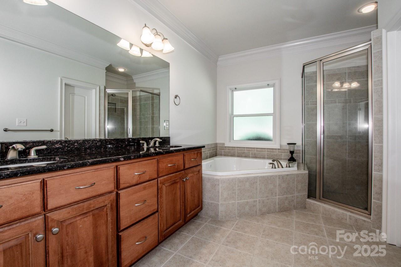 3545 Maple Brook Drive Denver, NC 28037 - Photo 20 of 40 a spacious bathroom with a bathtub sink and mirror