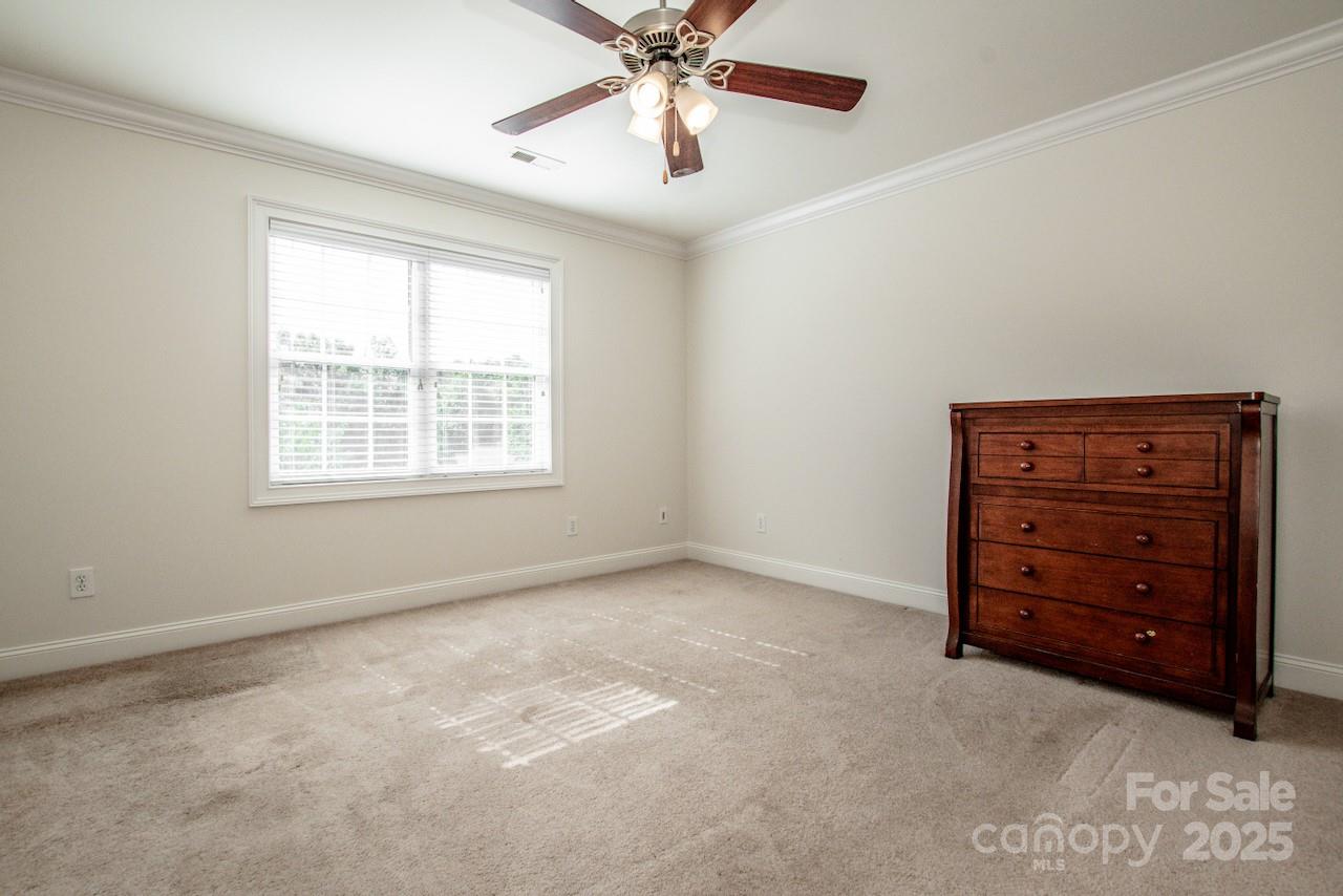 3545 Maple Brook Drive Denver, NC 28037 - Photo 27 of 40 a view of an empty room with a ceiling fan and a window
