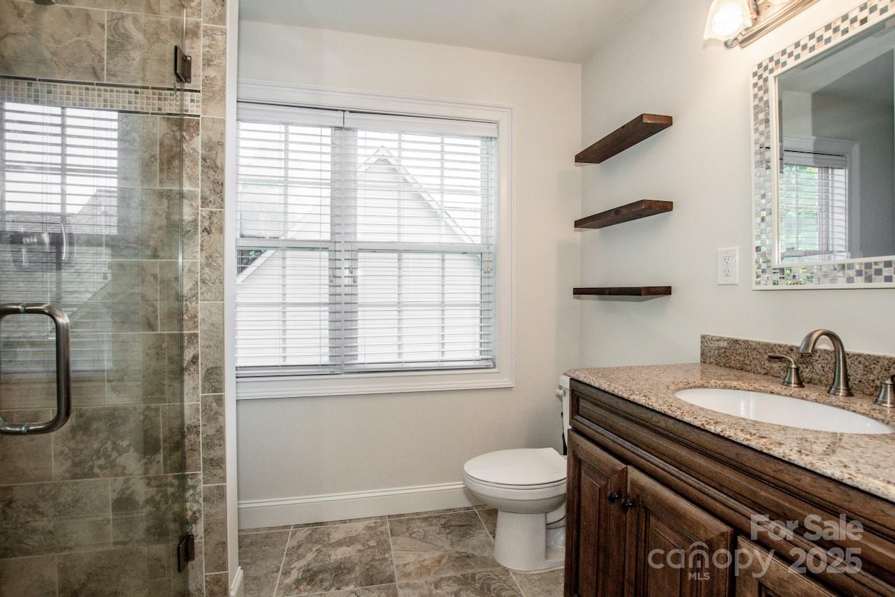 3545 Maple Brook Drive Denver, NC 28037 - Photo 31 of 40 a bathroom with a granite countertop sink toilet and shower