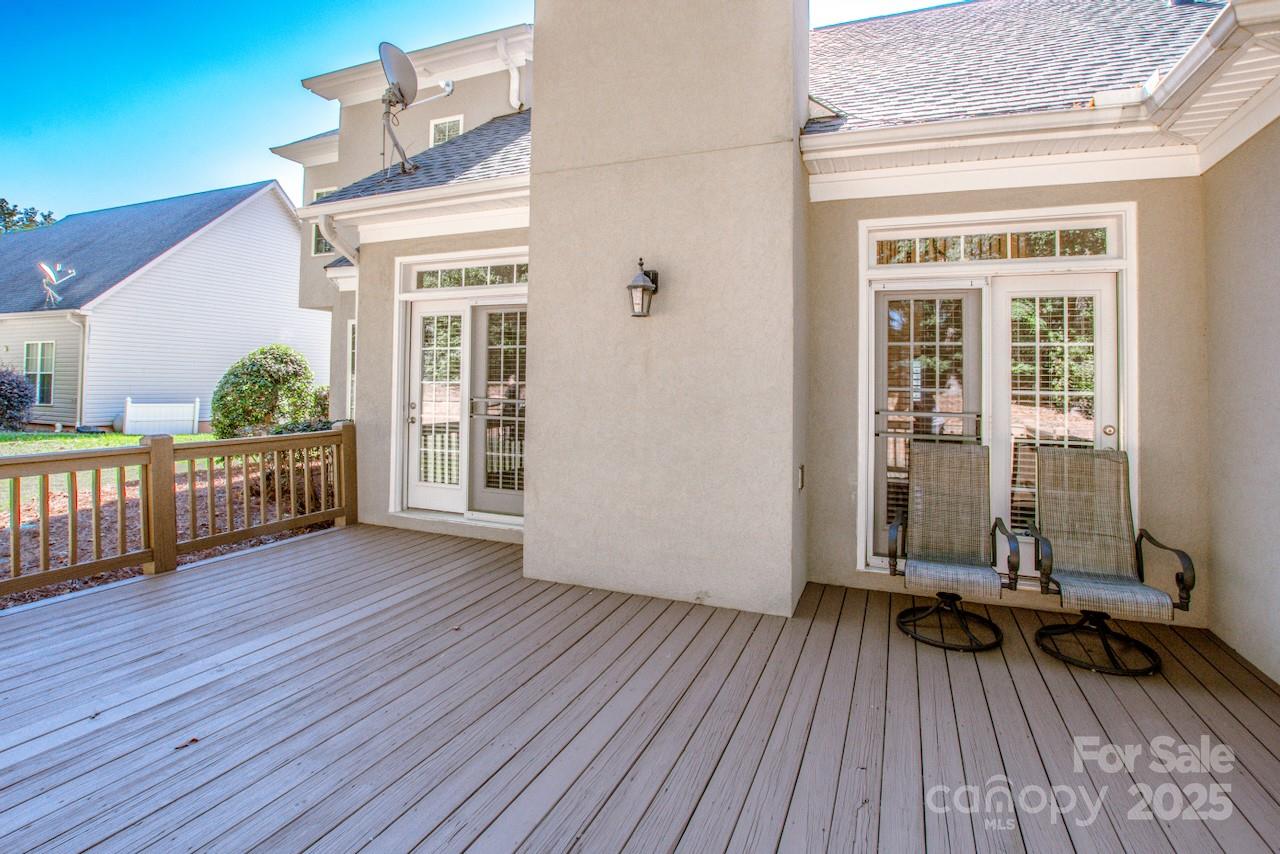3545 Maple Brook Drive Denver, NC 28037 - Photo 35 of 40 a view of a deck with wooden floor and floor to ceiling window