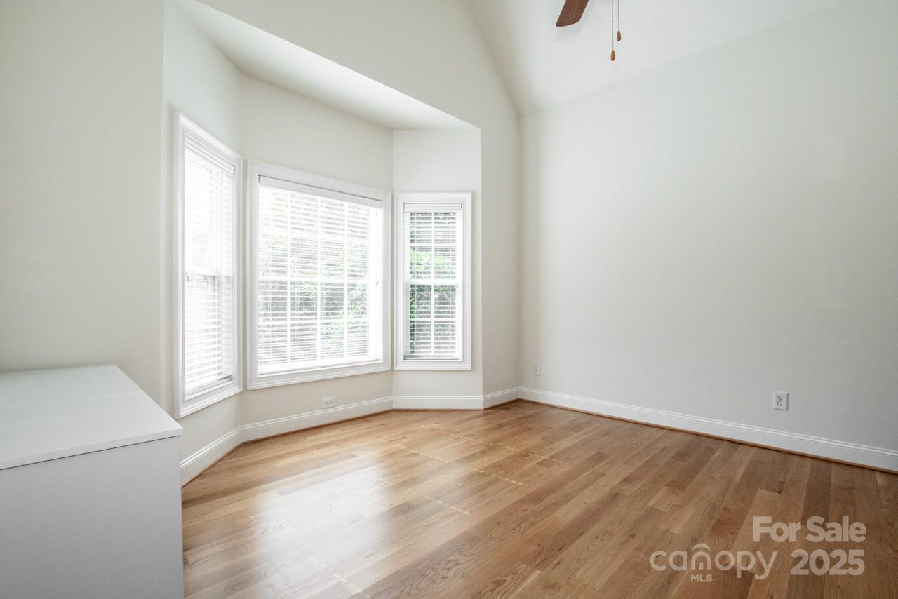 3545 Maple Brook Drive Denver, NC 28037 - Photo 6 of 40 a view of an empty room with wooden floor and a window