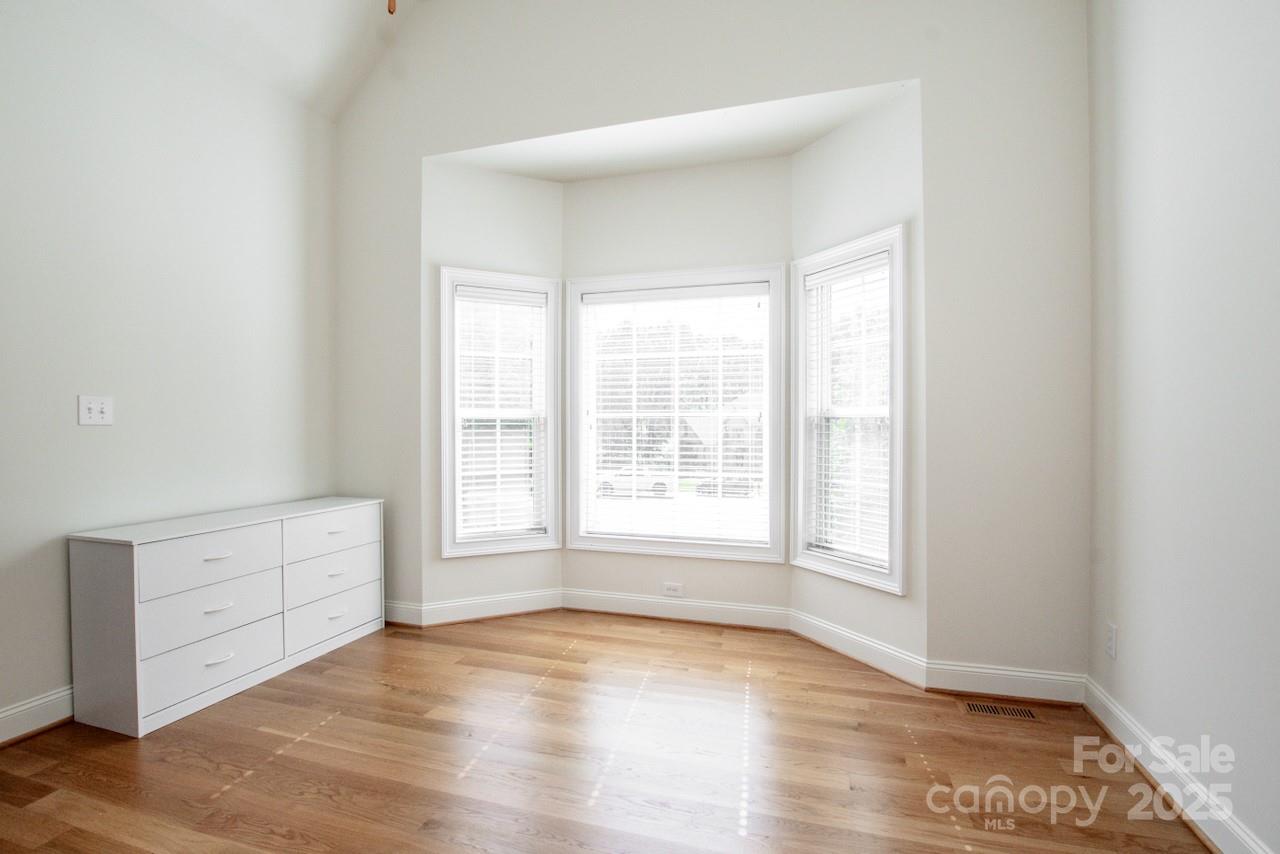 3545 Maple Brook Drive Denver, NC 28037 - Photo 7 of 40 an empty room with wooden floor and windows
