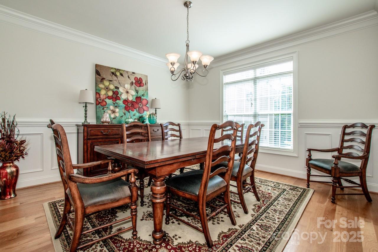 3545 Maple Brook Drive Denver, NC 28037 - Photo 8 of 40 a dining room with furniture a chandelier and wooden floor