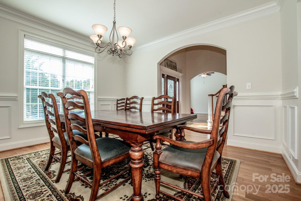 3545 Maple Brook Drive Denver, NC 28037 - Photo 10 of 40 a dining room with furniture a chandelier and wooden floor
