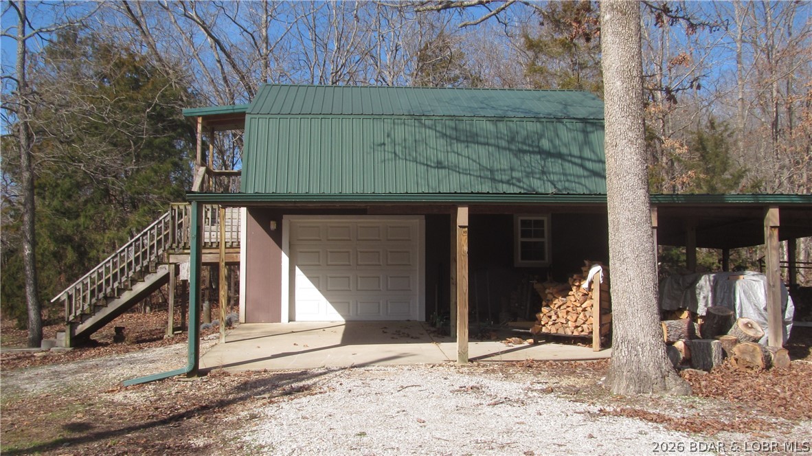 144 Chipmunk Drive Edwards, MO 65326 - Photo 31 of 40 Barn Shaped Garage on Hobby property has carport,