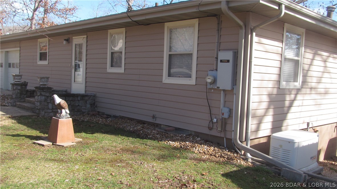 144 Chipmunk Drive Edwards, MO 65326 - Photo 6 of 40 Close- up of front of home. Well is located under