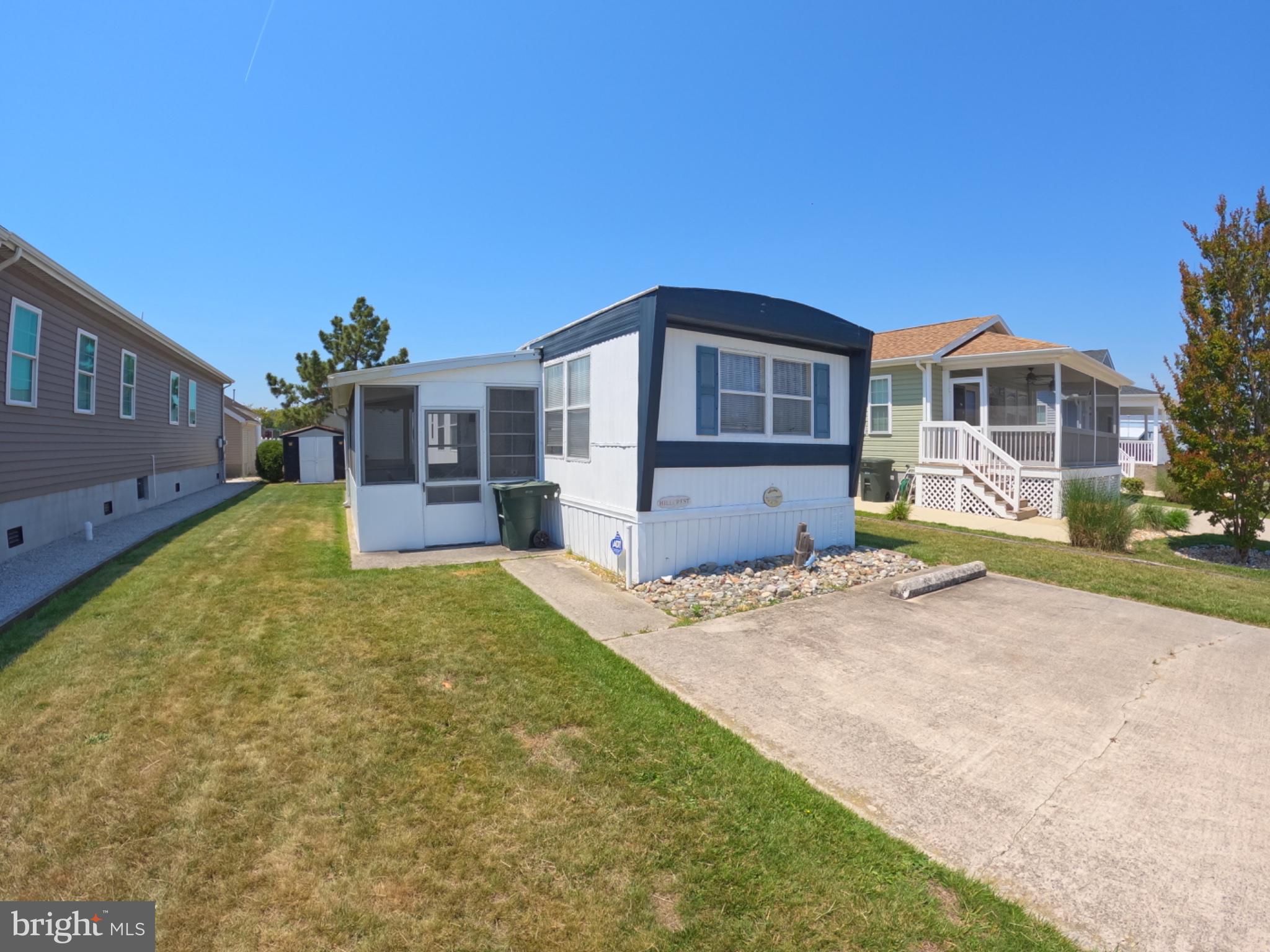 163 Clamshell Road Ocean City, MD 21842 - Photo 2 of 18 a front view of a house with a yard and garage