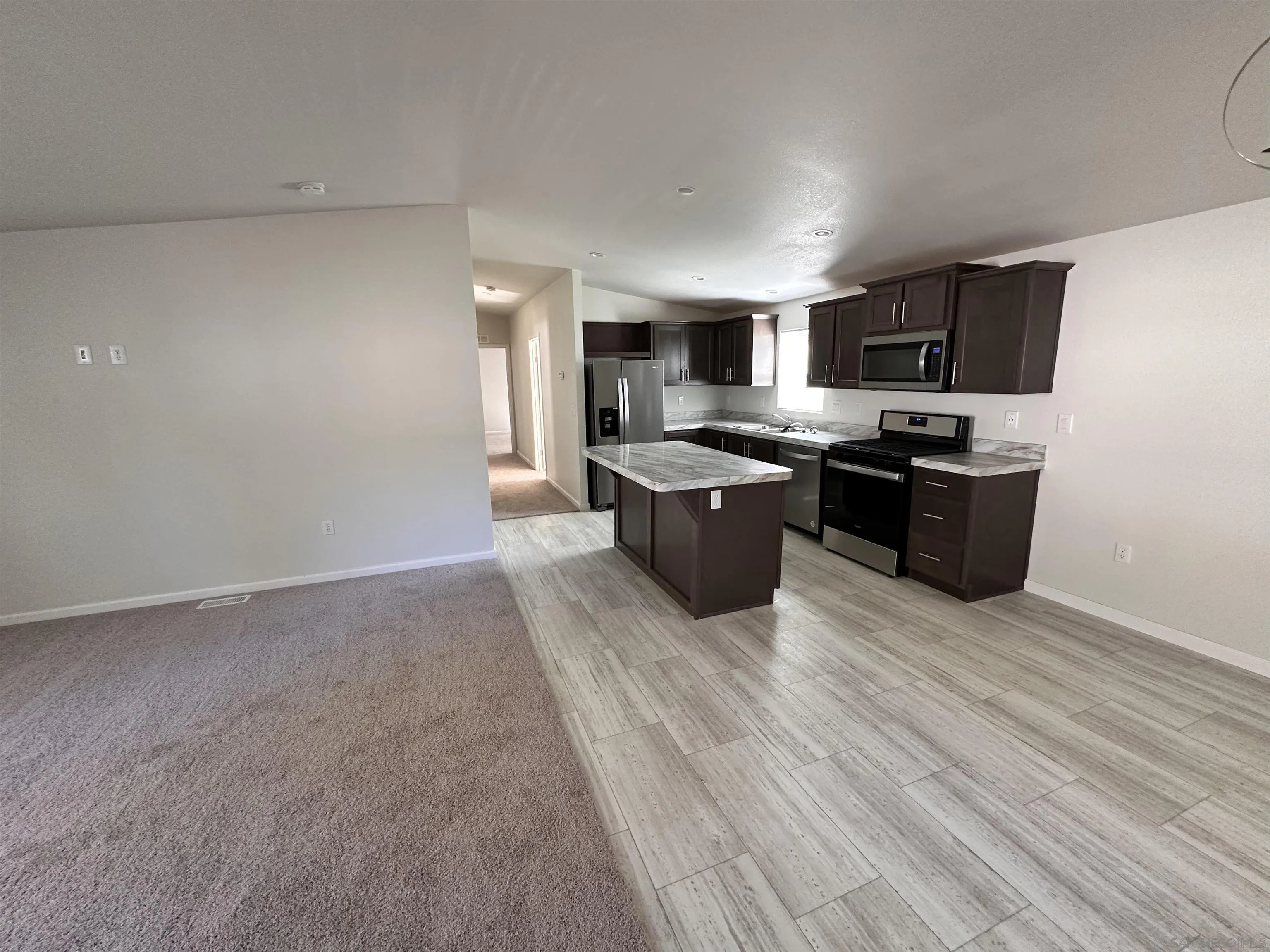 22899 Byron Road, Unit 110 Crestline, CA 92325 - Photo 4 of 5 a view of a kitchen with stove top oven and cabinets