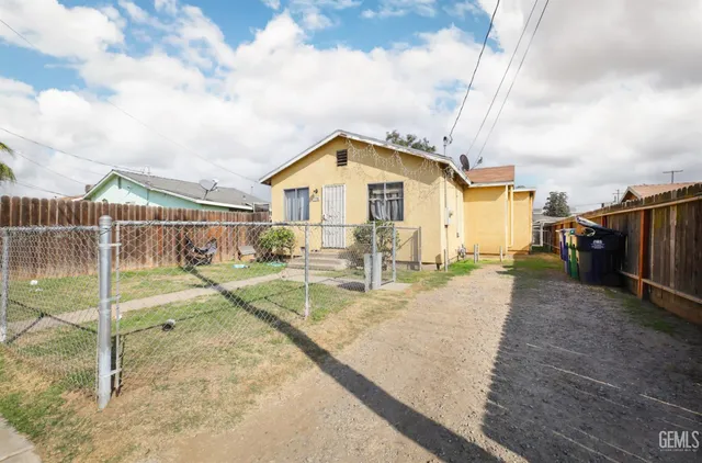 a backyard of a house with table and chairs