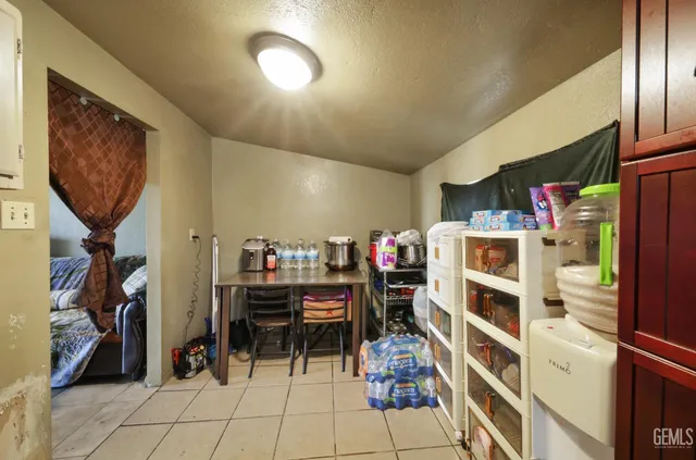 a dining room with furniture and a kitchen
