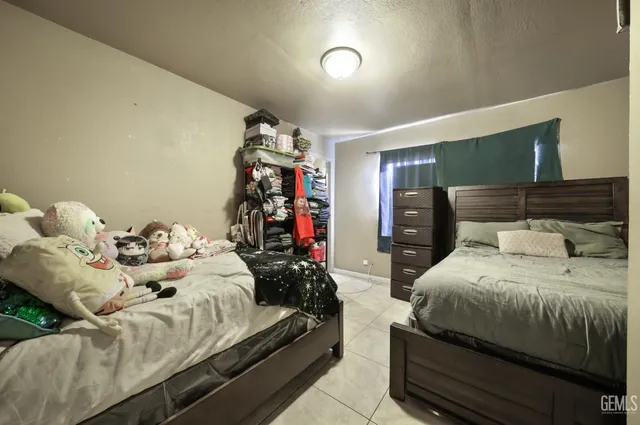 a large bedroom with a bed and glass wall